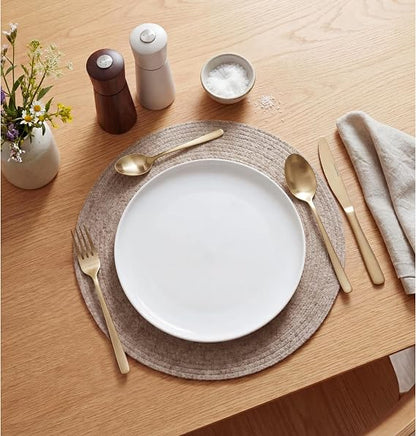 Top-down view of the 32-piece Russell Hobbs Vienna gold satin stainless steel cutlery set neatly arranged on a dark wooden table setting.