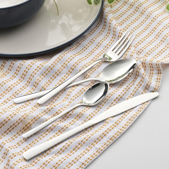 Silver Russell Hobbs Vienna 24-piece stainless steel cutlery set with mirror finish arranged neatly on a dining table.