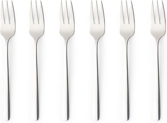 Six pack of silver polished 18/0 stainless steel Russell Hobbs Vienna dessert forks arranged neatly on a dark wooden dining table.
