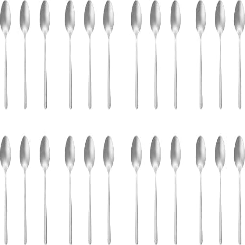 Top-angle view of 24 shiny silver Russell Hobbs Vienna polished stainless steel teaspoons arranged neatly on a wooden kitchen counter.