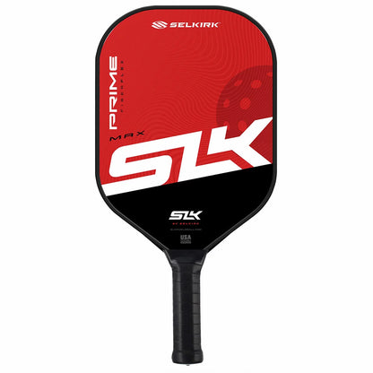 A close-up studio shot of two SLK Prime Max pickleball paddles in red and blue finishes, resting alongside three high-durability yellow pickleball balls and a black protective sling bag.