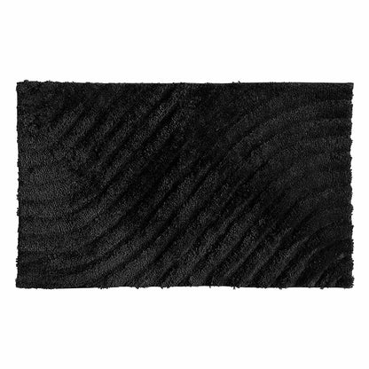 Overhead angled view of the plush grey Safdie Tufted Wave Bath Mat showing its sculpted high-low wave pattern on a light tiled bathroom floor.