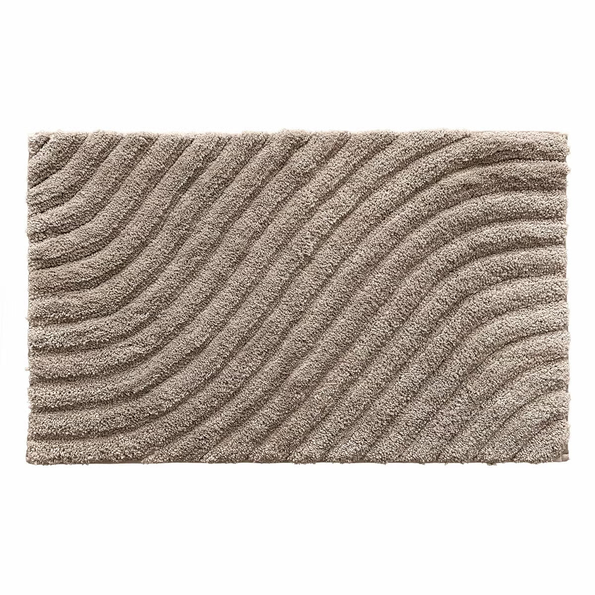Overhead angled view of the plush grey Safdie Tufted Wave Bath Mat showing its sculpted high-low wave pattern on a light tiled bathroom floor.