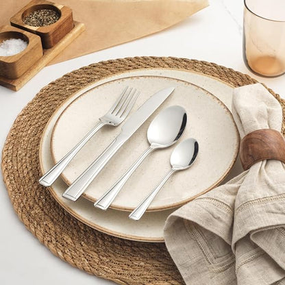 Salter Buxton 16-piece mirror-polished silver stainless steel cutlery set arranged neatly on a dark wooden table setting.