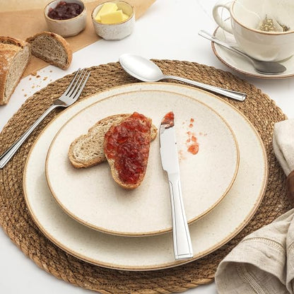 Salter Buxton 16-piece mirror-polished silver stainless steel cutlery set arranged neatly on a dark wooden table setting.