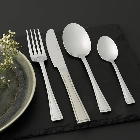 Silver polished Salter Buxton 48 piece stainless steel cutlery set arranged neatly on a dark wooden table.