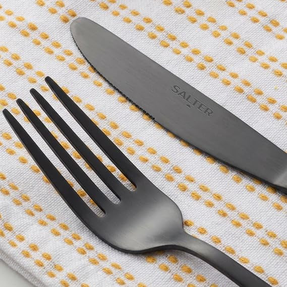 Overhead view of the 16-piece Salter Chiltern cutlery set in brushed matte black stainless steel arranged neatly on a dark slate dining table.