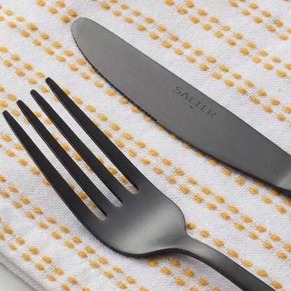 Overhead view of the 16-piece Salter Chiltern cutlery set in brushed matte black stainless steel arranged neatly on a dark slate dining table.