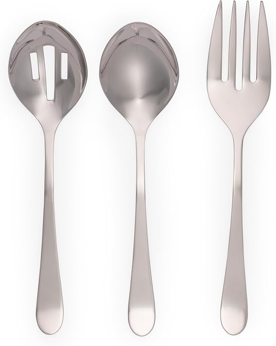 Salter Dalton three piece mirror polished stainless steel serving set featuring a solid spoon, slotted spoon, and fork laid out on a dark wooden dining table.