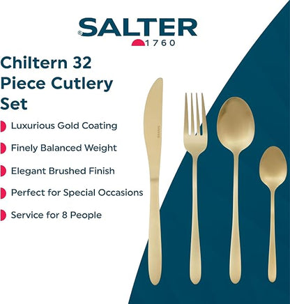 Close-up of Salter Chiltern 32-piece brushed gold stainless steel cutlery set arranged neatly on a dark slate dining table.