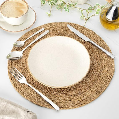 Salter Harrogate Kendal 16 piece mirror polished 18/10 stainless steel cutlery set neatly arranged on a wooden dining table.