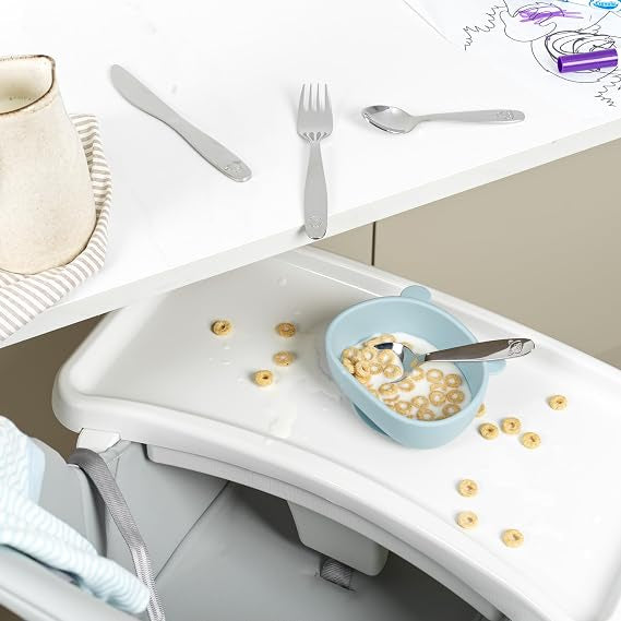 Salter 12-piece stainless steel kids cutlery set with farmyard animal engravings laid out on a clean light table setting.