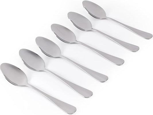 Six silver Salter Newbury polished stainless steel teaspoons neatly arranged side by side on a light wooden tabletop.