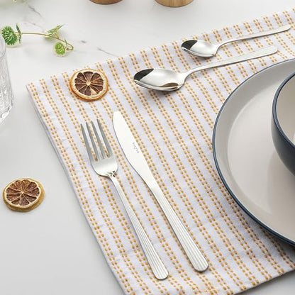 Salter Prestbury 16 piece silver stainless steel cutlery set arranged on a modern dining table showcasing a polished mirror finish.