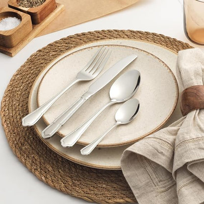 Salter Richmond 24 piece silver stainless steel cutlery set neatly arranged on a dark wooden dining table showcasing polished knives, forks, and spoons.