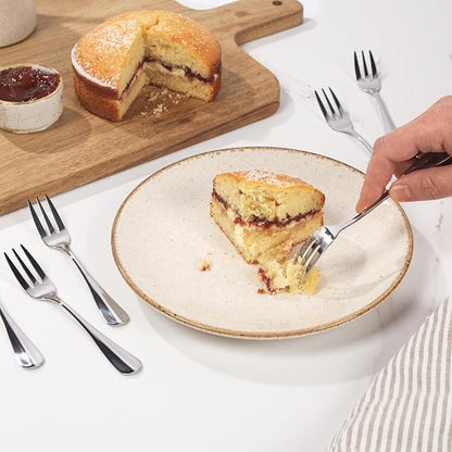 Silver Salter Soho 16-piece 430 stainless steel cutlery set arranged neatly for four place settings on a wooden dining table.