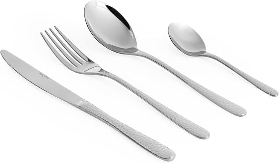 Top-down view of the 16-piece silver Salter Soho cutlery set arranged neatly on a grey linen tablecloth featuring polished knives, forks, tablespoons, and teaspoons.