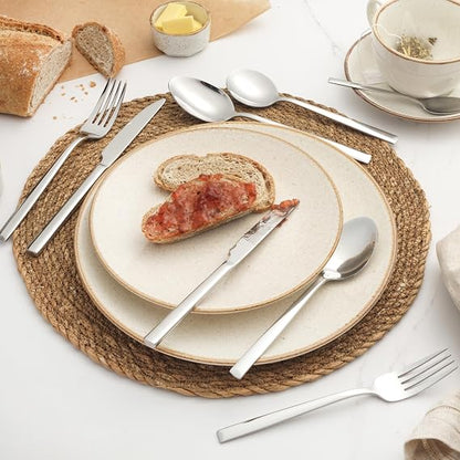 Silver Salter Winslow 44-piece polished stainless steel cutlery set arranged neatly on a dark wooden dining table setting.