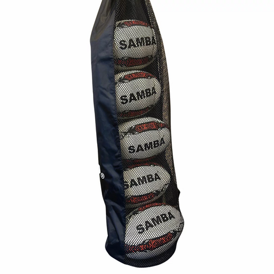 Five white and blue hand-stitched Samba Racer rugby training balls neatly stacked inside a clear nylon tube bag sitting on a green grass pitch.