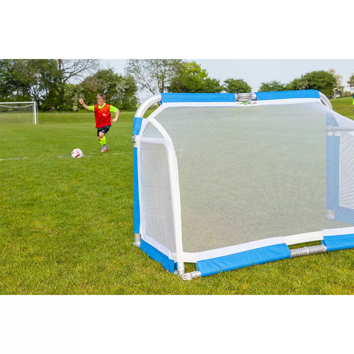 Pair of silver Samba 5ft x 3ft folding aluminium goals with black nets set up opposite each other on a green grass football pitch.
