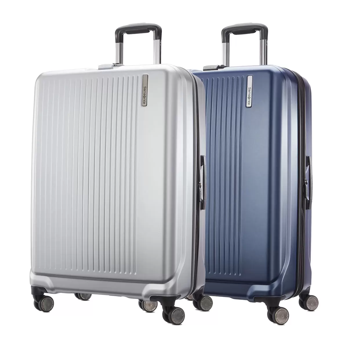 Samsonite Amplitude large hardside case in metallic finish standing upright in a sleek airport terminal corridor.