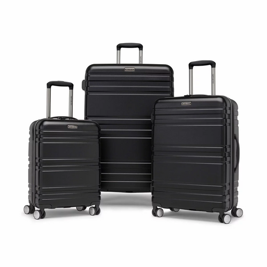  Samsonite Parallax 3 piece hardside luggage set stacked together in polished navy and grey finishes on a minimalist airport terminal floor. 