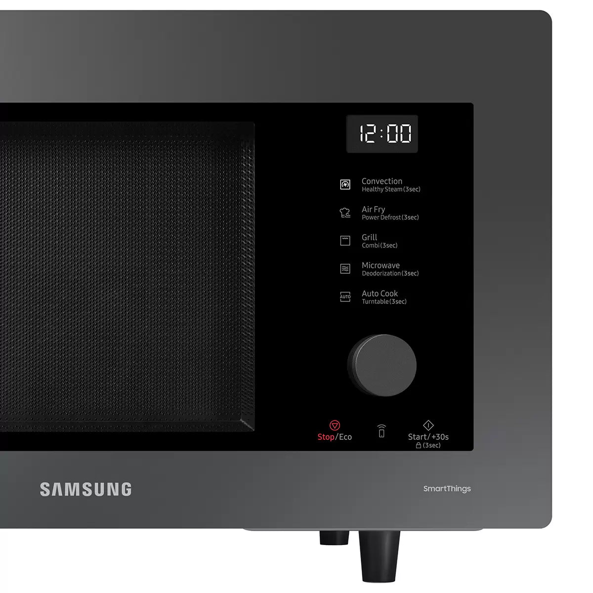 Black Samsung 32L smart microwave oven with glass door and digital control panel sitting on a contemporary kitchen countertop beside cooked food.