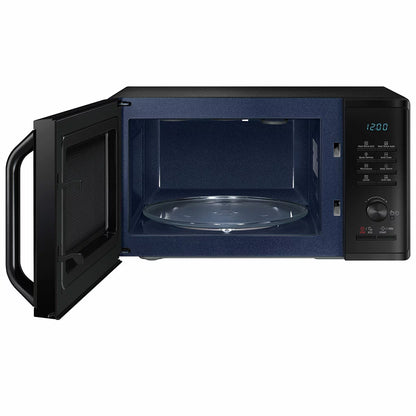 Front view of the black Samsung MG23K3575AK 23L Heat Wave microwave grill sitting on a modern kitchen counter with its digital display lit up.
