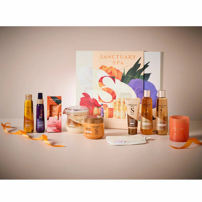 Front view of the 10-piece Sanctuary Spa Total Spa Collection Set in a luxury gift box resting on a white marble bathroom counter.