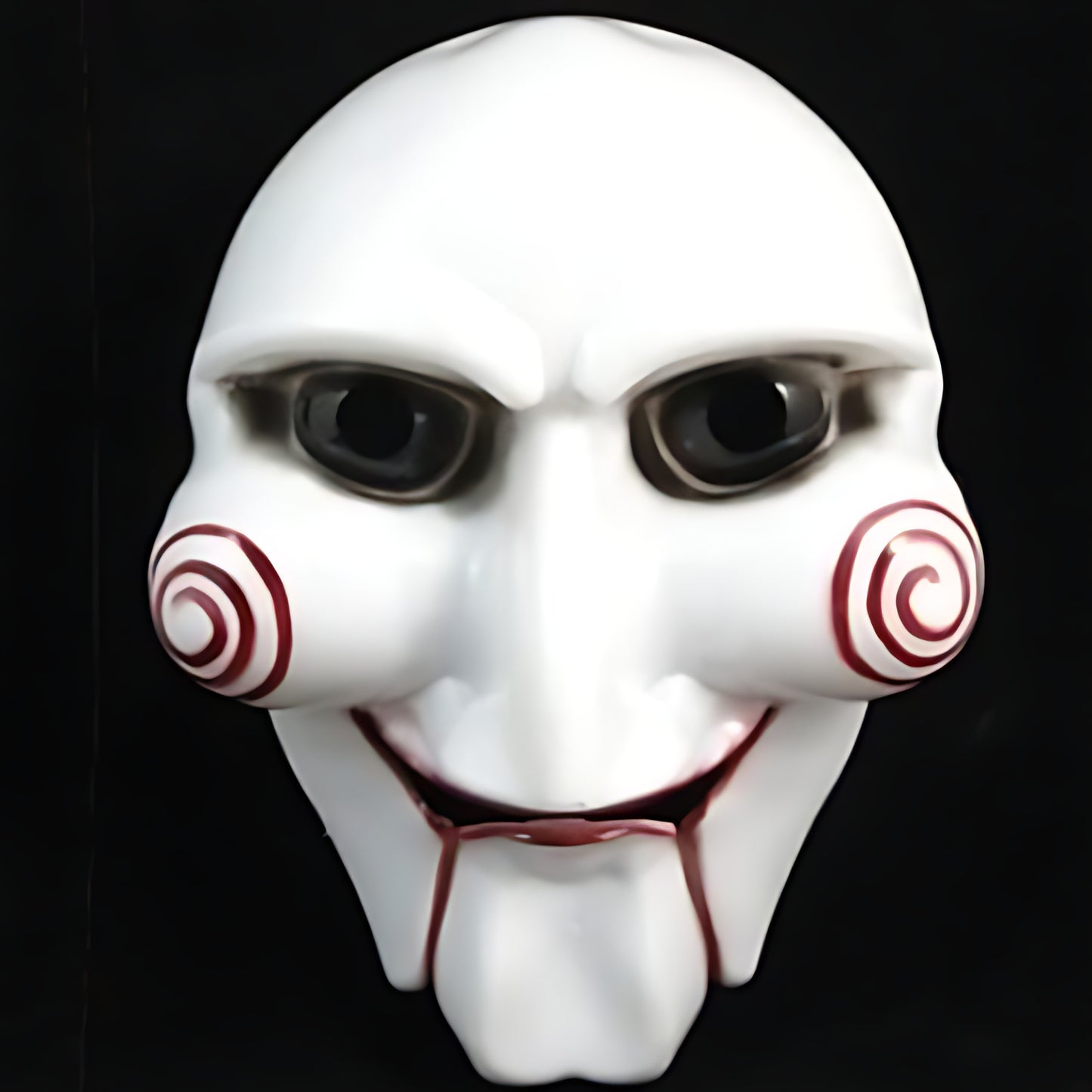 Front view of a white Saw Billy puppet horror mask with red spiral cheek details and red lips on a black background.