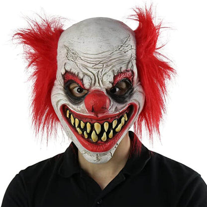 Front view of a detailed scary joker latex clown mask with red accents and realistic face contours against a plain background.