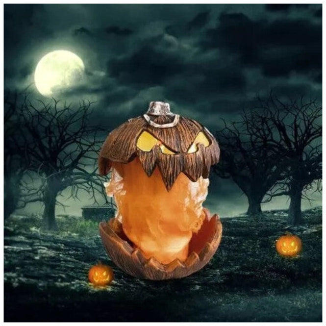 Front angle shot of a 20cm orange scary pumpkin animatronic prop with carved jagged teeth and glowing red LED eyes on a dark table.