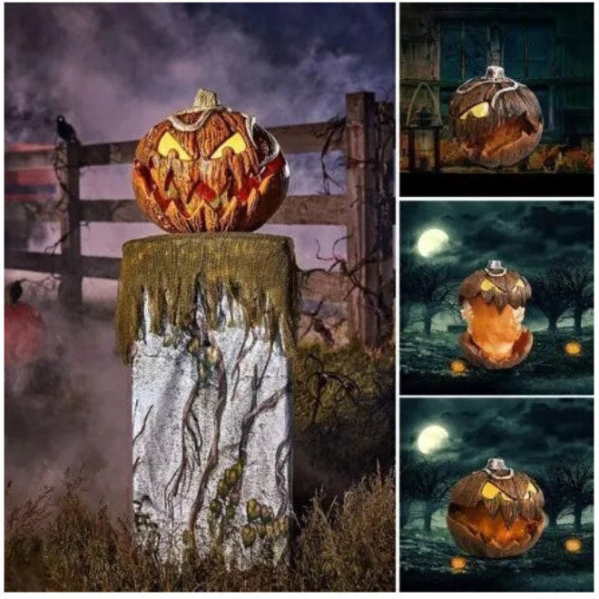 Front angle shot of a 20cm orange scary pumpkin animatronic prop with carved jagged teeth and glowing red LED eyes on a dark table.