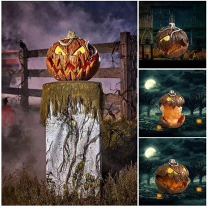 Front angle shot of a 20cm orange scary pumpkin animatronic prop with carved jagged teeth and glowing red LED eyes on a dark table.