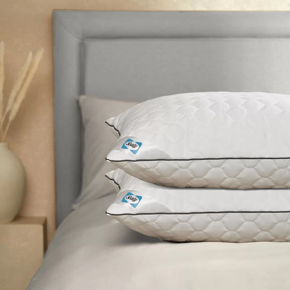 Pair of white Sealy Deeply Full Pillows showing off the quilted cotton cover texture while arranged on a contemporary bed frame.