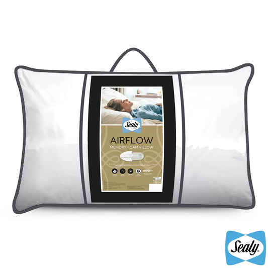 White Sealy Memory Airflow Pillow showing the quilted cotton surface and breathable grey air mesh sidewall details on a modern bed setup.