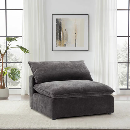 Front angle view of the Aiden & Ivy Sereen dark grey fabric armless chair, showcasing its textured upholstery, deep feather-blend seat, and clean minimalist profile in a contemporary apartment setting.