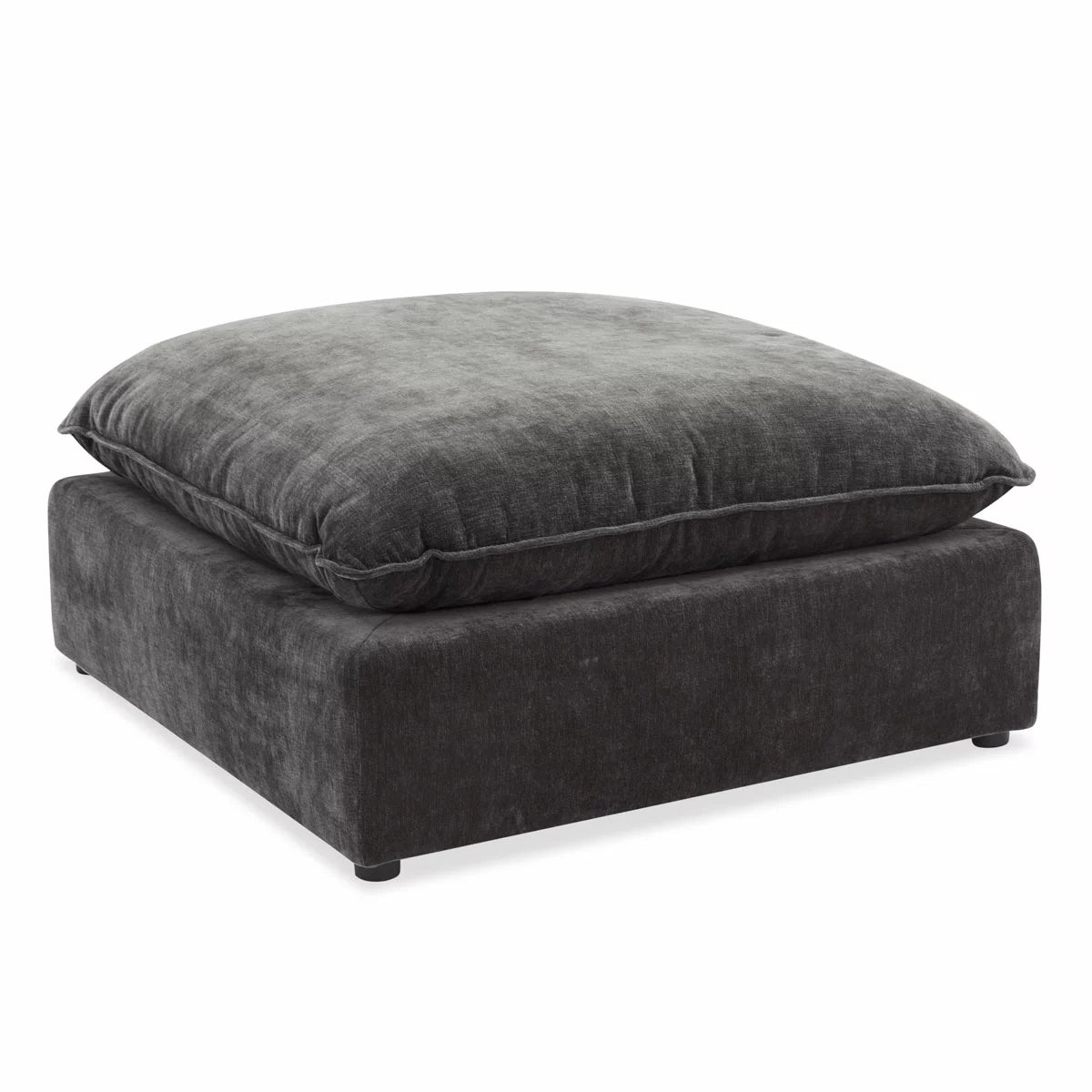 Angled studio shot of the square Sereen dark grey fabric ottoman, showcasing its thick, plush feather-blend cushion top and solid profile on a neutral background.