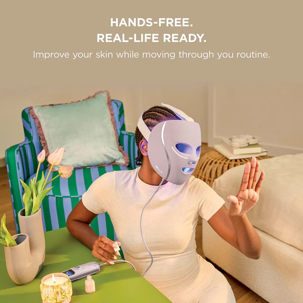 Shark CryoGlow LED therapy mask in Lilac Chill with silicone eye guards, attached handheld controller, and USB-C cable displayed on a white marble vanity.