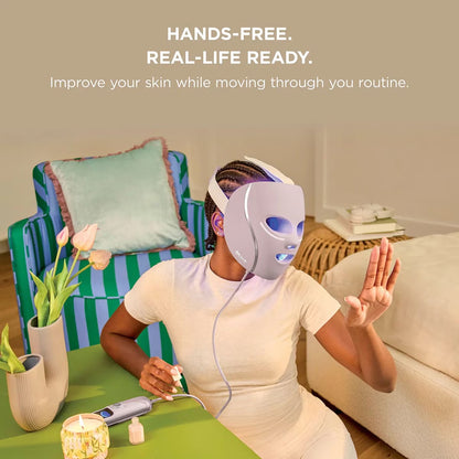 Shark CryoGlow LED therapy mask in Lilac Chill with silicone eye guards, attached handheld controller, and USB-C cable displayed on a white marble vanity.