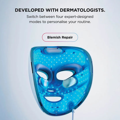 Shark CryoGlow LED therapy mask in Lilac Chill with silicone eye guards, attached handheld controller, and USB-C cable displayed on a white marble vanity.