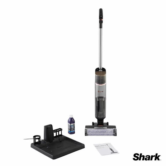 Front angle view of the slim metallic Shark HydroVac WD210UK cordless cleaner standing upright on its dark dock against clean kitchen tile flooring.
