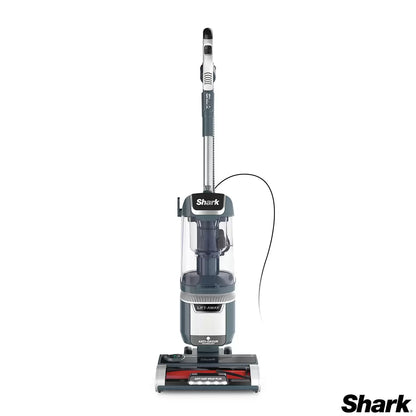 Front view of the Navy Shark Anti Hair Wrap Plus upright pet vacuum standing upright on light wood flooring in a modern living room setting.