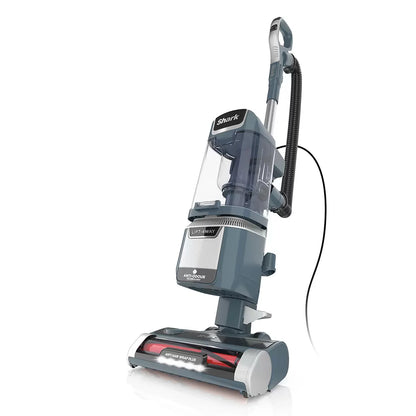 Front view of the Navy Shark Anti Hair Wrap Plus upright pet vacuum standing upright on light wood flooring in a modern living room setting.