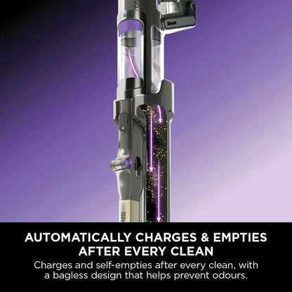 Front view of the dark teal Shark PowerDetect IP3251UKT cordless vacuum cleaner docked on its upright auto-empty charging base in a modern living room setting.