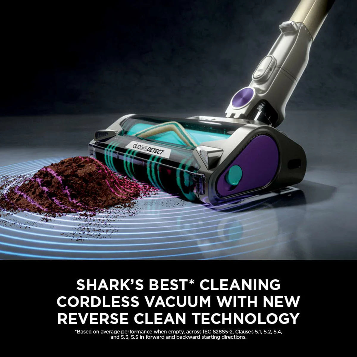 Front view of the dark teal Shark PowerDetect IP3251UKT cordless vacuum cleaner docked on its upright auto-empty charging base in a modern living room setting.