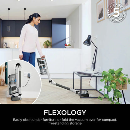 Shark PowerPro Pet Cordless Stick Vacuum IZ380UKT in use on carpet, removing pet hair with Anti Hair Wrap technology and cordless convenience.