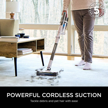 Shark PowerPro Pet Cordless Stick Vacuum IZ380UKT in use on carpet, removing pet hair with Anti Hair Wrap technology and cordless convenience.