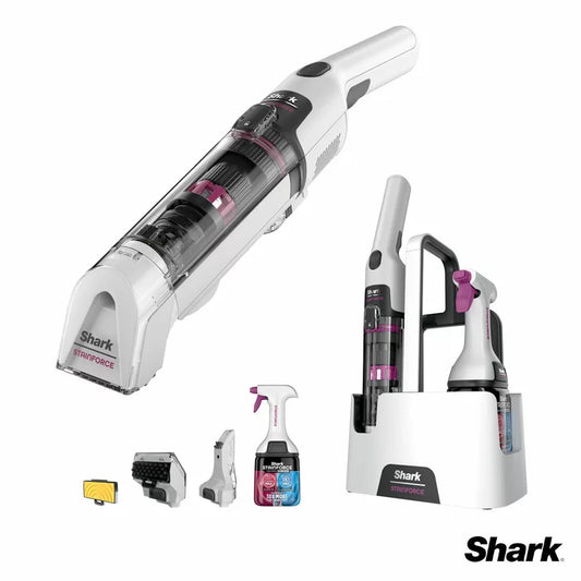 Shark StainForce HX100UKT cordless spot cleaner being used to remove a dark stain from a grey fabric sofa.