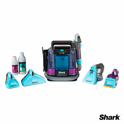 Front view of the white and deep navy Shark StainStriker HairPro PX250UKT spot cleaner sitting on a beige living room rug beside its attached hose and pet hair extraction tool.